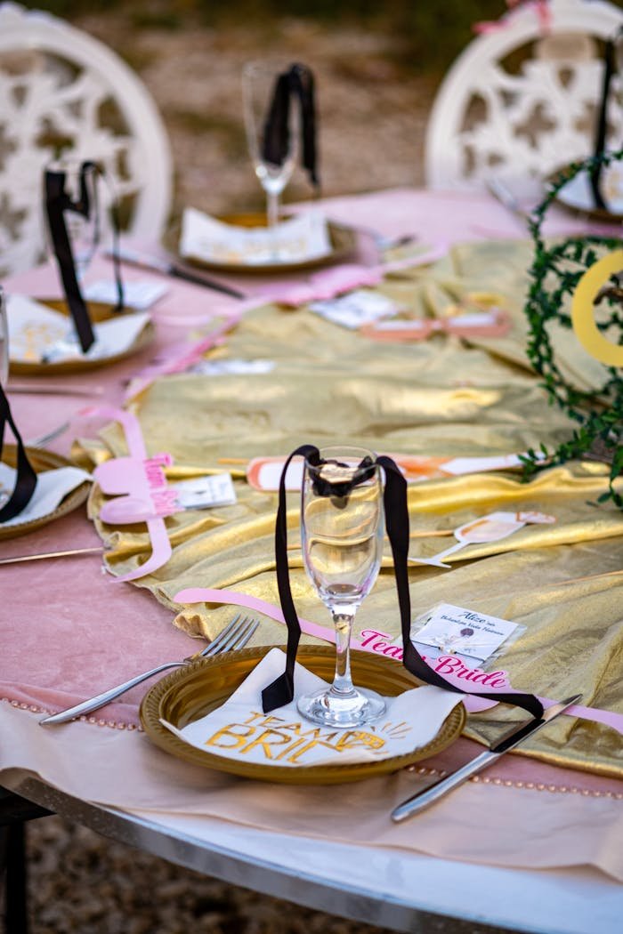 A chic outdoor bachelorette party setup featuring elegant tableware and decor.