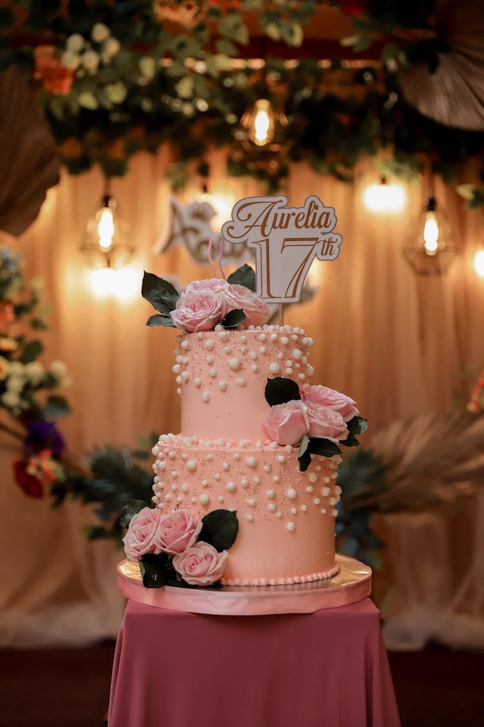 Beautiful pink two-tiered cake with roses for a 17th birthday celebration.