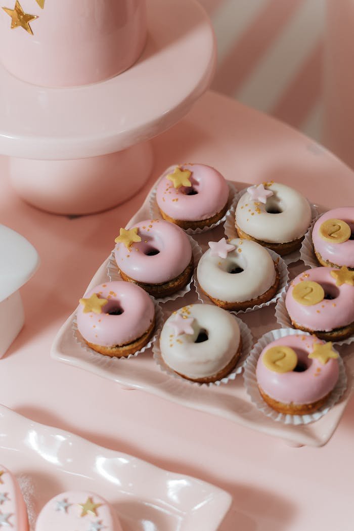 Stylish pink and white mini donut cupcakes with stars for a child's birthday party.